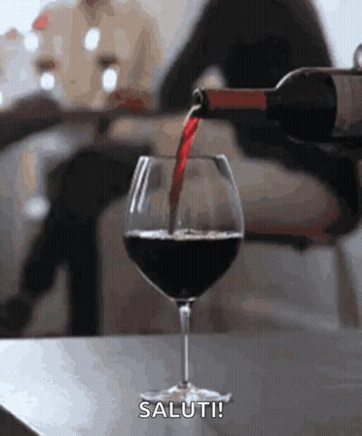 A Bottle Of Wine Is Being Poured Into A Glass With The Words Saluti Written Below It GIF
