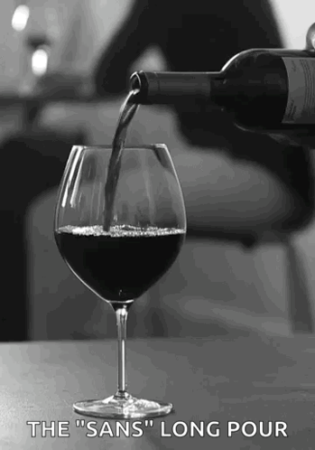 A Bottle Of Wine Is Being Poured Into A Glass With The Words " The Sans Long Pour " Below It . GIF