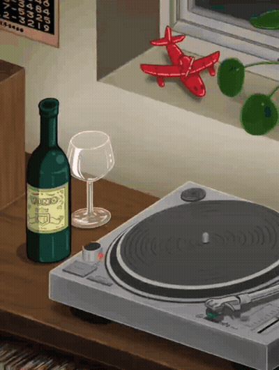 A Bottle Of Wine Sits Next To A Record Player And A Glass Of Wine GIF
