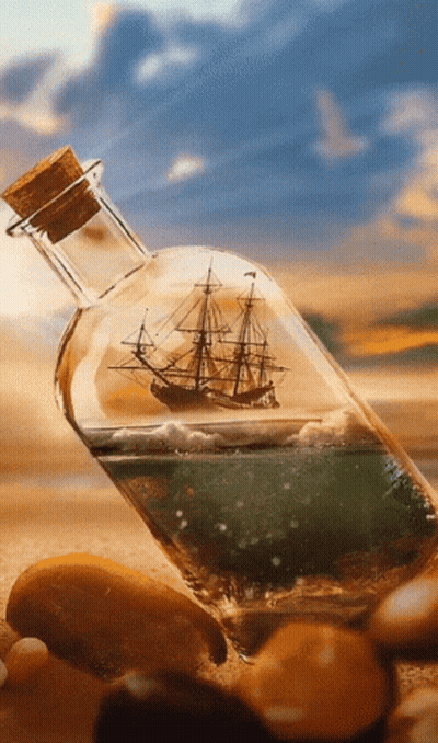 A Bottle With A Ship Inside Of It On A Beach GIF
