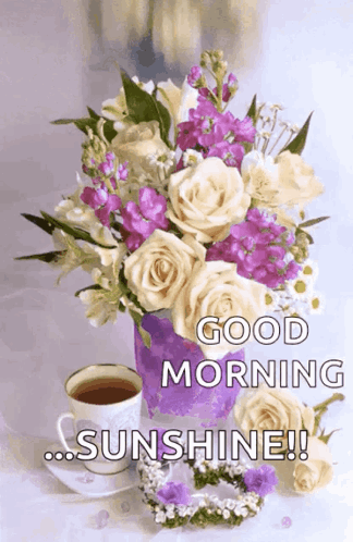 A Bouquet Of Flowers In A Purple Vase Next To A Cup Of Coffee GIF