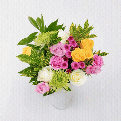 A Bouquet Of Flowers Including Pink Roses And A Yellow Lily GIF