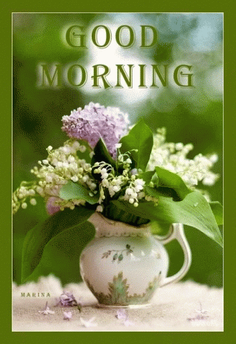 A Bouquet Of Lily Of The Valley Flowers In A Pitcher On A Green Background GIF