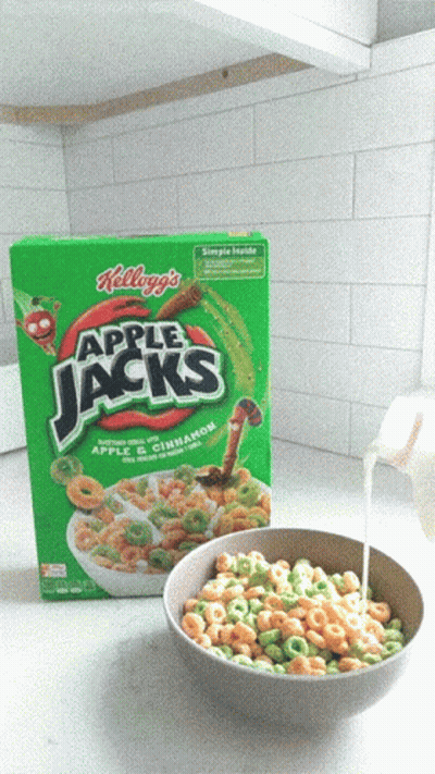 A Bowl Of Apple Jacks Cereal Next To A Box Of Cereal GIF