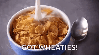 A Bowl Of Cereal With Milk Being Poured Into It And The Words `` Got Wheaties '' Written On The Bottom . GIF