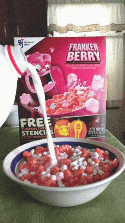 A Bowl Of Franken Berry Cereal With Milk Being Poured Into It GIF