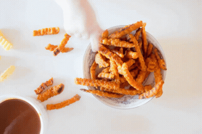 A Bowl Of French Fries And A Cup Of Dipping Sauce GIF