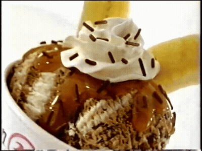 A Bowl Of Ice Cream With Whipped Cream And Chocolate Sprinkles GIF