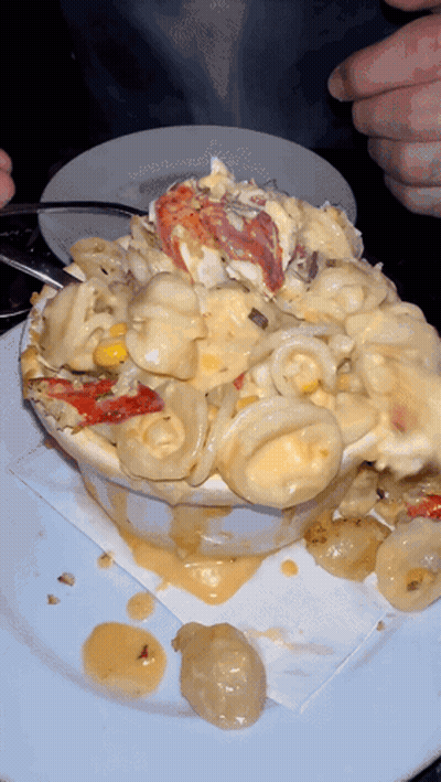 A Bowl Of Macaroni And Cheese With Lobster On Top GIF