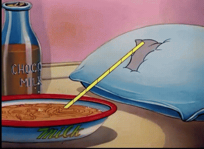 A Bowl Of Milk Sits On A Table Next To A Bottle Of Choco Milk GIF