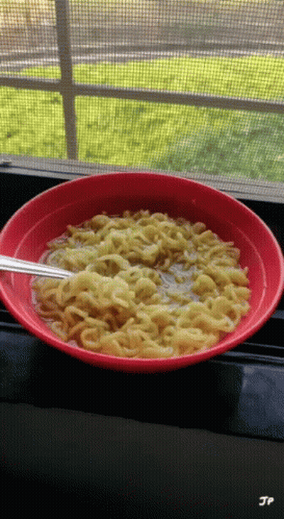A Bowl Of Noodles Sits On A Window Sill With Jp Written On The Bottom GIF