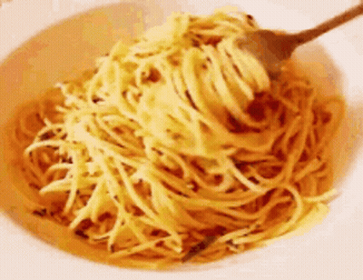 A Bowl Of Noodles With A Fork In It . GIF