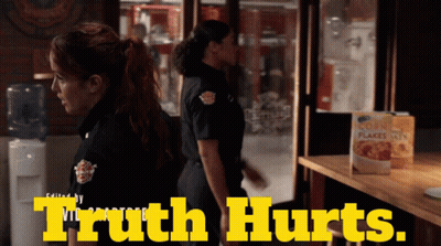 A Box Of Corn Flakes Sits On A Table Next To Two Women In Uniform GIF