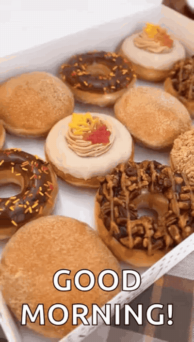 A Box Of Donuts With Sprinkles And Frosting And The Words `` Good Morning '' Written On It . GIF