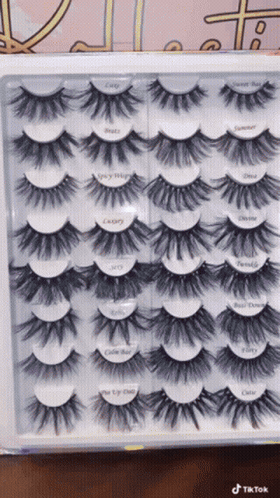 A Box Of Fake Eyelashes With Labels On Them Including One That Says ' Cutie ' GIF