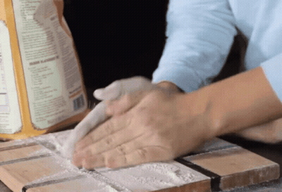 A Box Of Flour Sits On A Cutting Board GIF