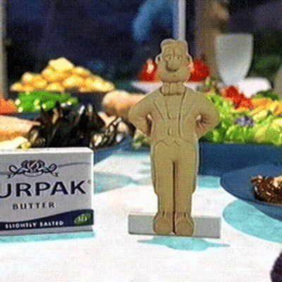 A Box Of Jrpak Butter Sits On A Table Next To A Figurine GIF