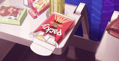 A Box Of Milk Chocolate Pocky Sits On A Tray GIF