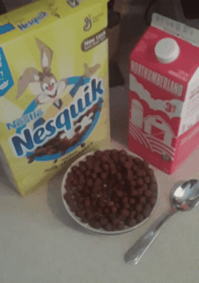 A Box Of Nesquik Cereal Sits Next To A Carton Of Northumberland Milk GIF