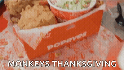 A Box Of Popeye 'S Fried Chicken Is On A Table GIF
