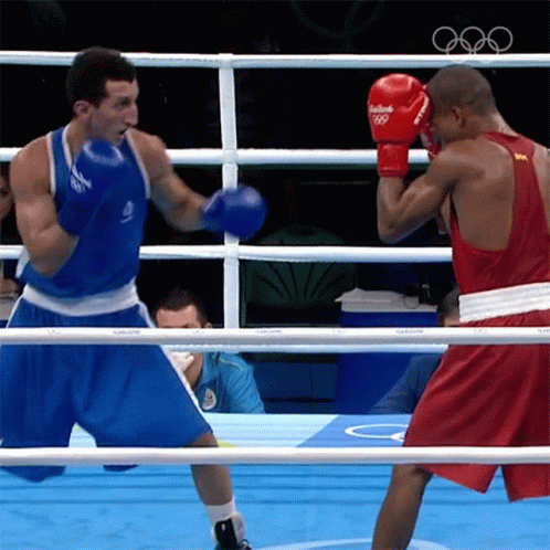 A Boxer Wearing Red Gloves That Say Rio 2016 GIF