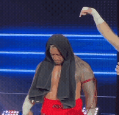 A Boxer With A Towel Wrapped Around His Head Is Getting Ready To Fight . GIF