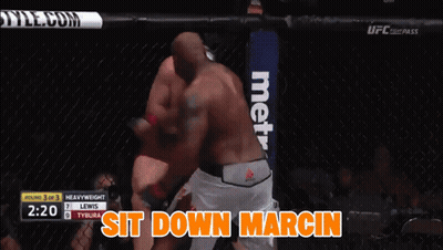 A Boxing Match Between Lewis And Tybura With The Words Sit Down Marcin On The Bottom GIF