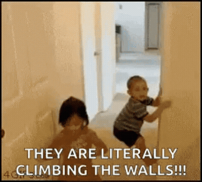A Boy And A Girl Are Climbing The Walls In A Room . GIF