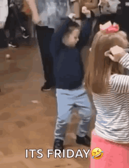 A Boy And A Girl Are Dancing In A Room With A Caption That Says `` It 'S Friday '' . GIF