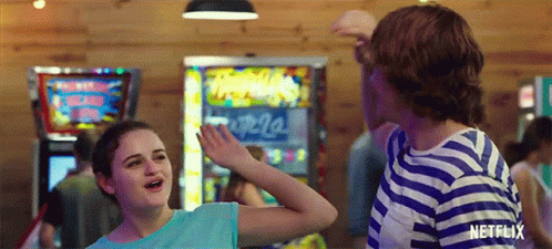 A Boy And A Girl Are Dancing In A Room With A Netflix Logo On The Bottom GIF