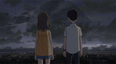 A Boy And A Girl Are Holding Hands In Front Of A City GIF