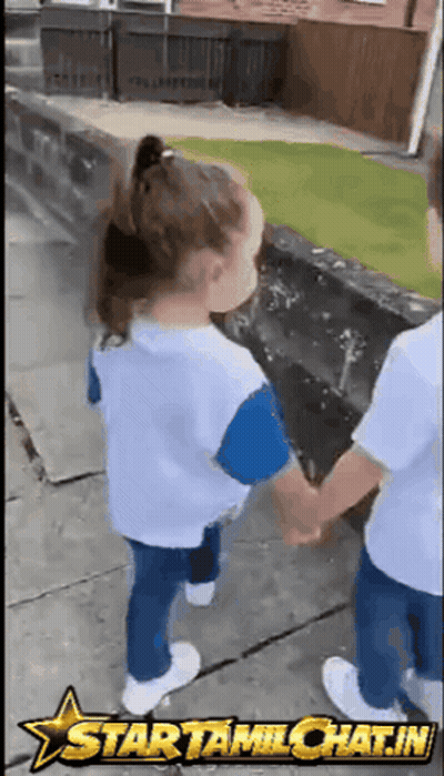 A Boy And A Girl Are Holding Hands On A Sidewalk With A Star Tamichat.in Logo Behind Them GIF