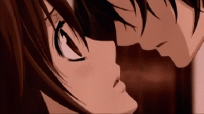 A Boy And A Girl Are Kissing Each Other In A Close Up Of Their Faces . GIF