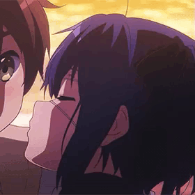 A Boy And A Girl Are Kissing In A Cartoon . GIF