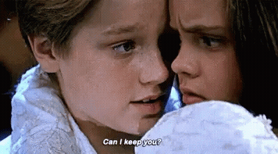 A Boy And A Girl Are Looking At Each Other And The Boy Is Asking The Girl If She Can Keep Him . GIF