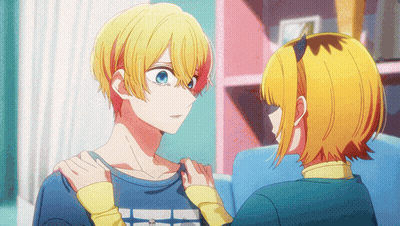 A Boy And A Girl Are Looking At Each Other And The Girl Is Holding The Boy 'S Arm GIF