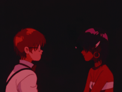 A Boy And A Girl Are Looking At Each Other And The Girl Is Wearing A Shirt That Says Sai GIF