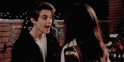 A Boy And A Girl Are Looking Into Each Other 'S Eyes GIF
