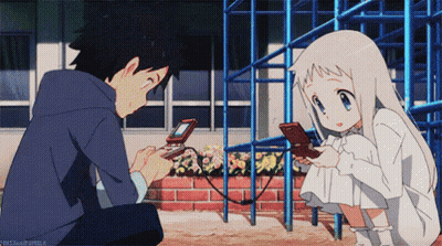 A Boy And A Girl Are Playing A Video Game And The Girl Is Looking At Her Phone GIF