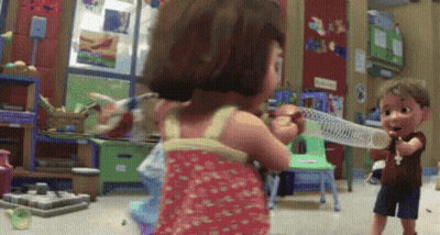 A Boy And A Girl Are Playing With A Slinky Toy In A Play Room GIF