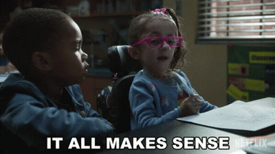 A Boy And A Girl Are Sitting At A Table With The Words " It All Makes Sense " Written On The Bottom GIF