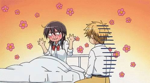 A Boy And A Girl Are Sitting Next To Each Other On A Bed With Flowers Flying Around Them . GIF