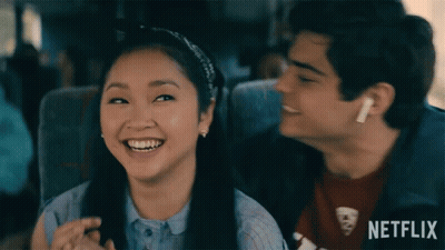 A Boy And A Girl Are Sitting Next To Each Other On A Bus With Netflix Written On The Bottom GIF
