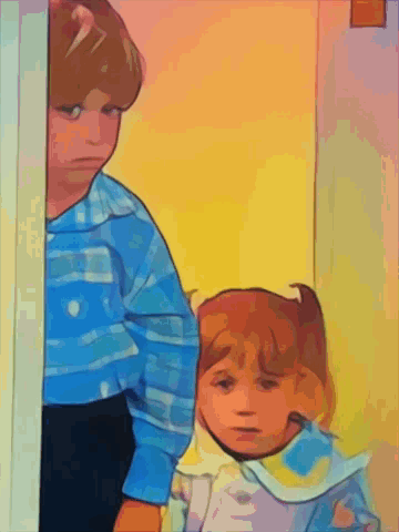 A Boy And A Girl Are Standing In A Doorway GIF
