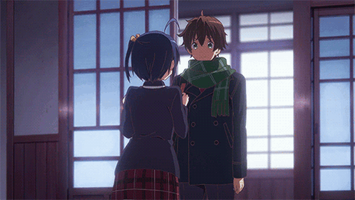 A Boy And A Girl Are Standing In Front Of A Window GIF