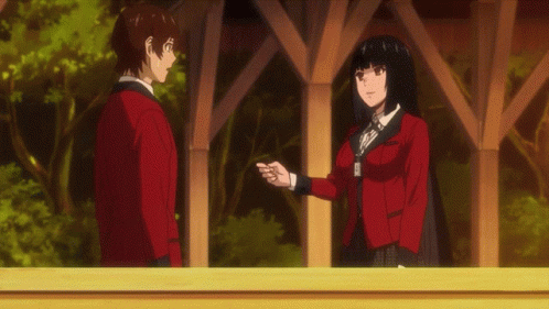 A Boy And A Girl Are Standing Next To Each Other And The Girl Is Giving The Boy A Card GIF