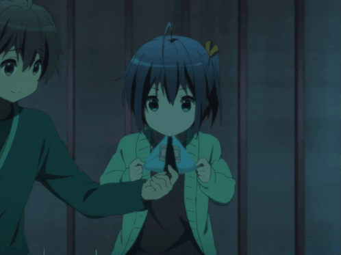 A Boy And A Girl Are Standing Next To Each Other And The Girl Is Wearing A Green Sweater GIF