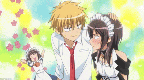A Boy And A Girl Are Standing Next To Each Other And The Girl Is Wearing A Maid Costume . GIF