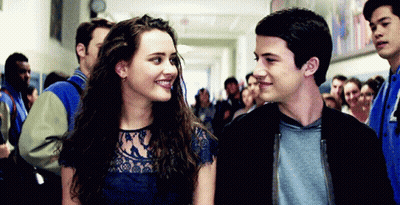 A Boy And A Girl Are Standing Next To Each Other In A Hallway . GIF