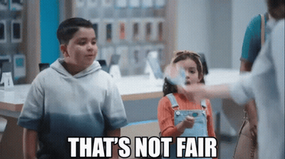 A Boy And A Girl Are Standing Next To Each Other In A Store With The Words That 'S Not Fair Written Above Them . GIF